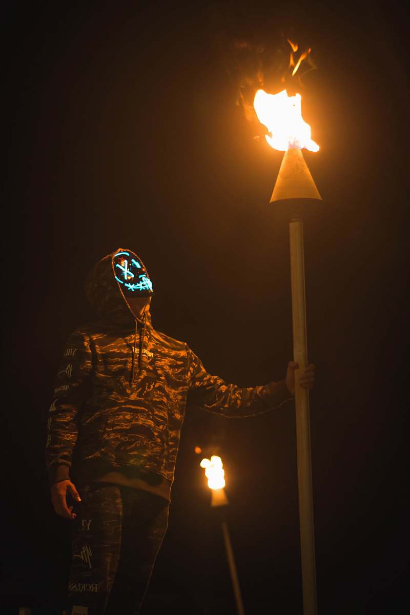 united states person holding torch while walking at night hilo